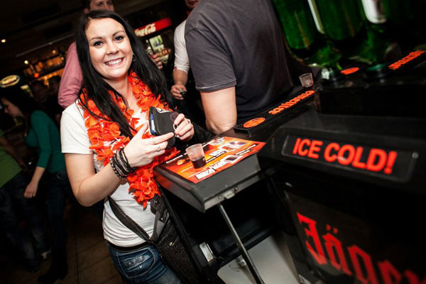 Woman drinking Jaegermeister shot in a club event